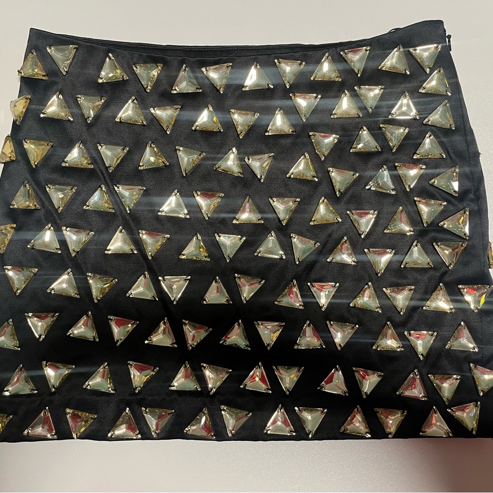 Bejeweled black Bebe miniskirt size 0. NWOT